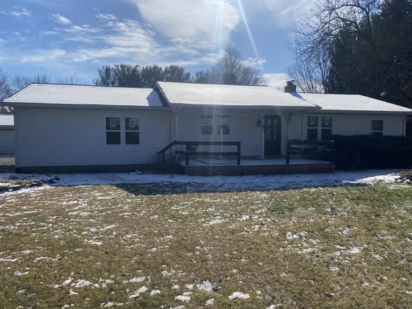 The same Johnstown home after Shields Roofing and Siding installed white siding and gutters